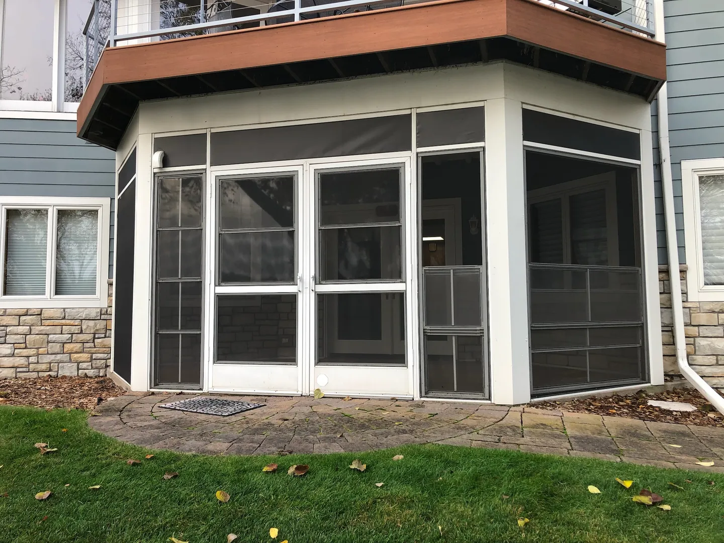 Screened-in bay porch in fall, screens dark and porch closed off